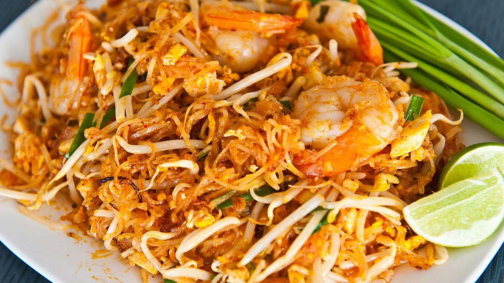 86. Pad Thai Noodles · Medium spicy, Thin rice noodles pan fried with egg, chili powder,  green onions, bean sprouts and your choice of protein topped crushed peanuts and side with a wedge of lime.