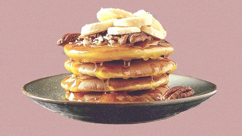 Banana Nut Pannies · 2 banana pancakes served with maple syrup, banana slices, toasted pecans, butter, and dusted with powdered sugar.