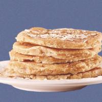 Coconut Pannies · 2 coconut pancakes served with maple syrup, shredded coconut, butter, and dusted with powder...