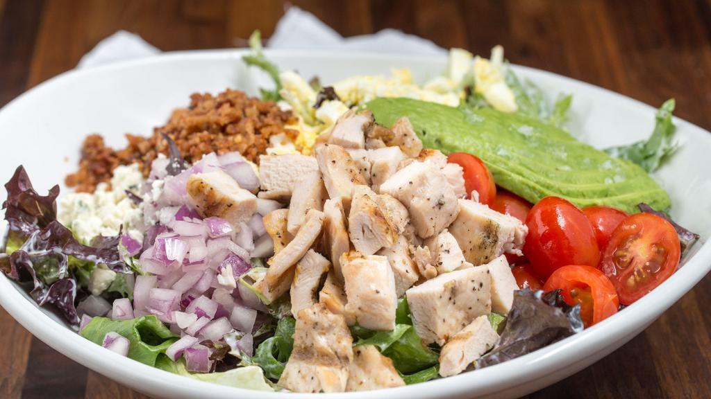 Cobb Salad · Chicken, blue cheese, egg, avocado, bacon, tomatoes, red onions, and ranch.
