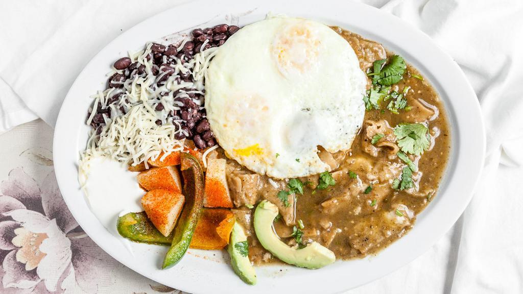 Chilaquiles  · Corn tortilla chips scrambled with eggs cooked in a red or green sauce topped with jack cheese, served with potatoes, beans, and sour cream
