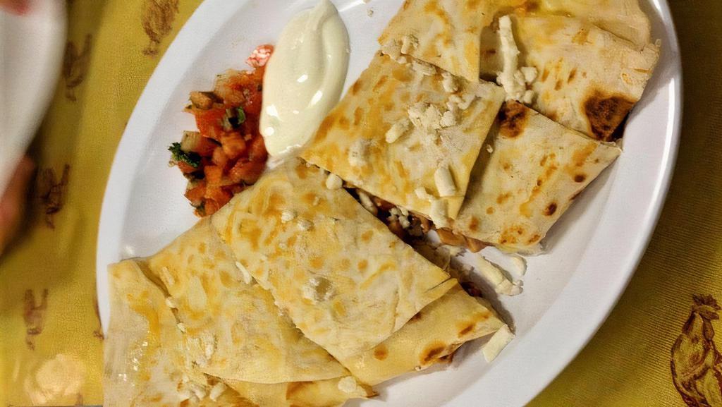 Quesadilla · Corn or flour tortilla filled with cheese and served with salsa fresca.