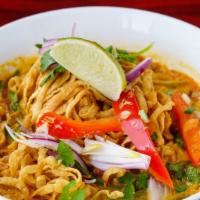 48. Chaing Mai Noodles (Kao Soy Thai) · Egg noodles served in light yellow curry soup with chicken, pickled mustard greens and red o...