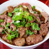 55. Beef Noodle Soup · Thai style beef noodle soup served with sliced beef, beef balls, and bean sprouts.