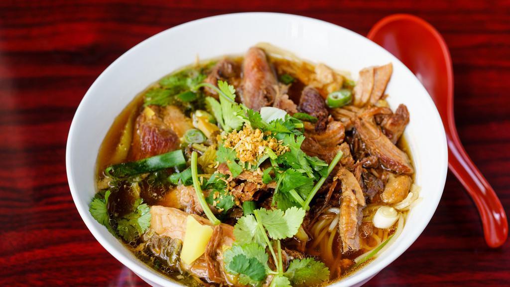 52. Pork Leg Stew Noodle Soup · Pork leg stew soup served with noodle, pickled mustard greens and bean sprouts.