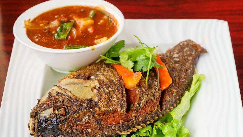 88. Pla Rad Prig (Whole Fish) · Hot. Deep fried whole tilapia topped with red bell pepper, onions, chili paste and crispy basil leaves.