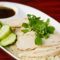 32. Kao Man Gai · Steamed chicken over garlic rice served with garlic and ginger sauce.