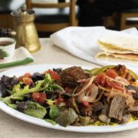 Kafta Kabab Wrap · Charbroiled Seasoned beef and lamb , hummus, Tahini Sauce, grilled onion and tomatoes in a L...