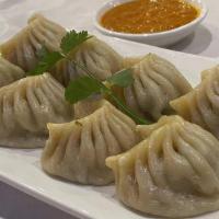 Chicken Momo · Ground-chicken mixed with Nepalese spices and diced onions wrapped on thin flour.