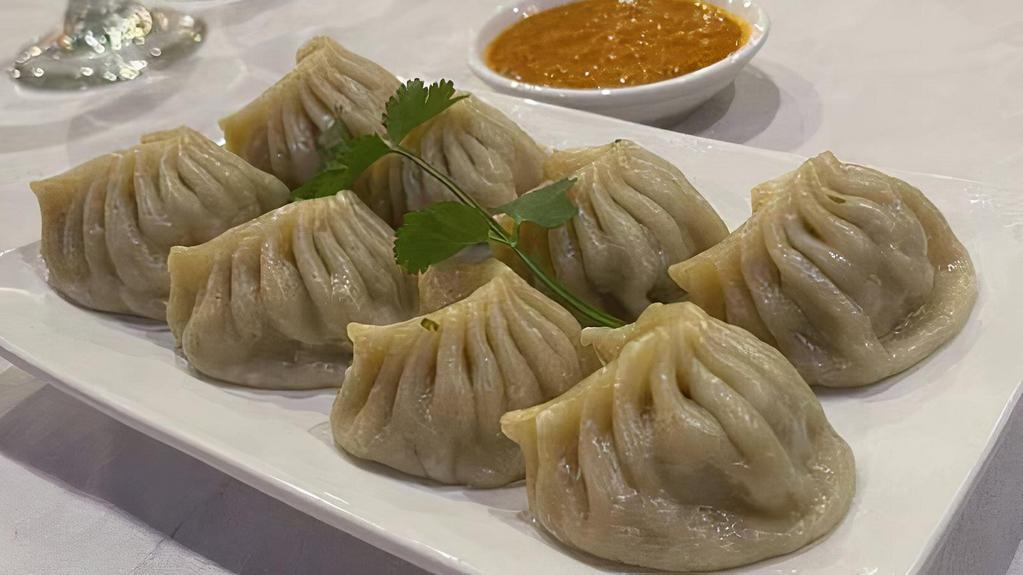Chicken Momo · Ground-chicken mixed with Nepalese spices and diced onions wrapped on thin flour.