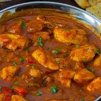 Chicken Curry-Bone · Bone in chicken cooked in onion and tomato base gravy sauce with Indian spices.