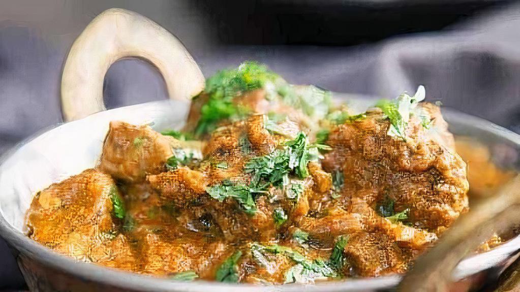 Lamb Korma · Mildly spiced lamb cooked with ground nuts and spices on a creamy sauce.