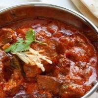 Lamb Vindaloo · Boneless lamb and potatoes cooked with spices on thick curry sauce.