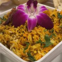 Vegetable Biryani · Long-grained rice cooked with seasonal vegetables and tomato onion base gravy layered with f...