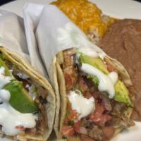 Super Taco Platter · Two super tacos in corn tortillas with meat of your choice, served with Mexican rice and ref...
