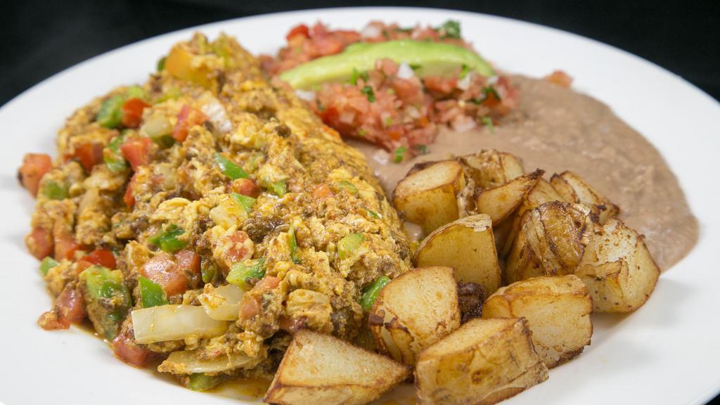 *Breakfast Plate · 3 Scrambled eggs with breakfast meat, sautéed onions, bell peppers and tomatoes. Home grilled potatoes & refried beans. Your choice of corn or flour tortillas.