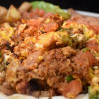 *Machaca Plate · Scrambled eggs, serranos, tomatoes, onions and carnitas served with refried beans, grilled p...