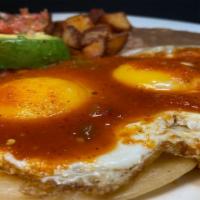 Huevos Rancheros Plate* · 2 eggs on top of grilled corn tortillas with ranchera sauce on top.served with refried beans...