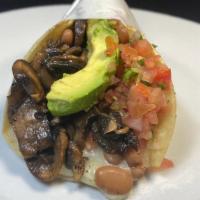 Super Veggie Taco · Fresh sauteed mushrooms in 2 corn tortillas, with melted cheese, whole beans, salsa fresca &...