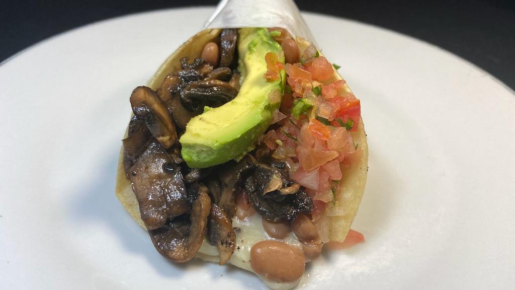Super Veggie Taco · Fresh sauteed mushrooms in 2 corn tortillas, with melted cheese, whole beans, salsa fresca & avocado
