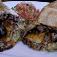 Super Plantain Burrito · Fried plantain with  melted cheese, brown rice, black beans, salsa, molcajete, avocado and s...