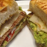 Churrasco Torta · Grilled Steak in a hot french roll with melted  cheese, mayonnaise, tomatoes and mashed avoc...