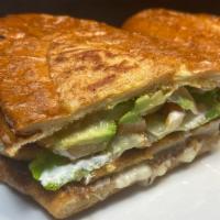 Torta de Milanesa Chicken · Breaded chicken in a hot french roll with melted cheese, mayonnaise, sour cream, lettuce, to...