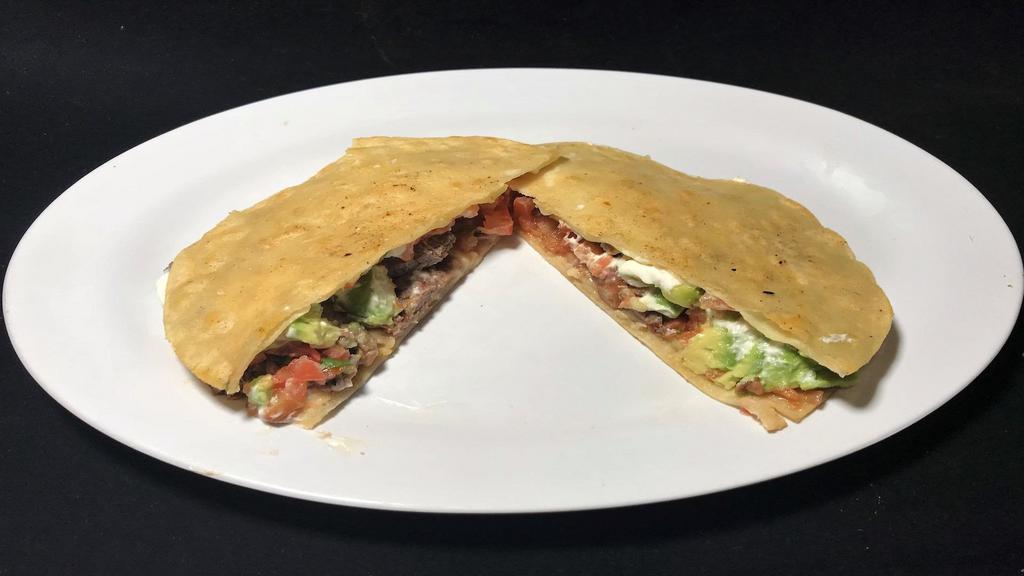 Mula Quesadilla · Two open faced corn tortilla with meat of your choice, melted cheese, salsa fresca, avocado, and sour cream.