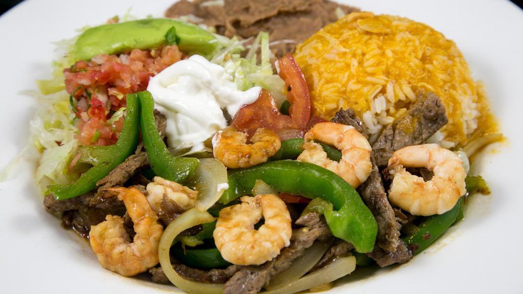 *Prawn & Steak Fajitas · Prawn and steak fajitas  with sauteed bell peppers, onions & tomatoes ,served with refried beans, Mexican rice,  avocado & small salad. Your choice of corn or flour tortillas.