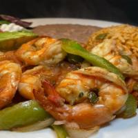 Prawn Fajitas · Grilled large prawns with sautéed onions, bell peppers and tomatoes.  served with refried  b...