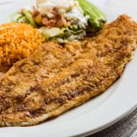 Fish Filet · A whole filet of sole, sautéed in butter, served with refried  beans, Mexican rice &  potato...