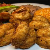 Camarones Empanizados · Eight breaded large  prawns served with refried beans, Mexican rice, salad & avocado slice. ...