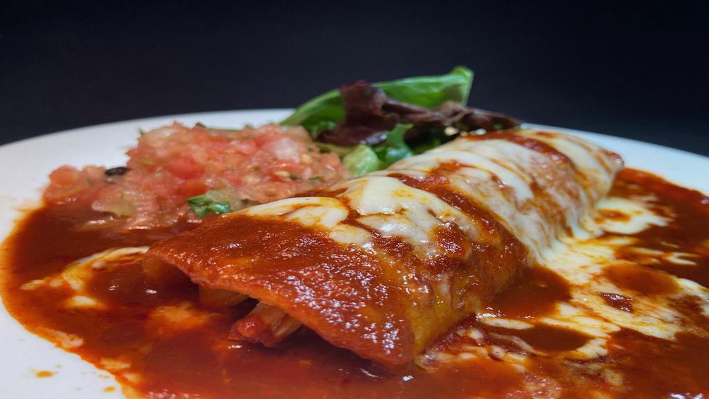 One Enchilada · A corn tortilla filled with chicken (or potato) and  your choice of enchilada sauce: green tomatillo, red tomato or creamy green suiza served with melted cheese on top & side salad.