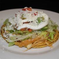 One Tostada · 2 corn crispy tortillas with your meat choice,  beans, lettuce, tomatoes, avocado, sour crea...