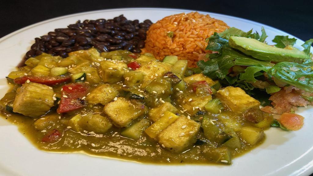 Vegan Chile Verde Tofu Plate · Sautéed veggies with tofu on a homemade  Chile verde sauce,  served with black beans, Mexican rice,  small salad & avocado slice. Your choice of corn or flour tortillas.