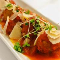 Bellini Meatball · Homemade beef meatball served with marinara sauce and parmesan cheese on top.