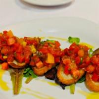 Bruschetta Al Pomodoro · Four pieces toasted slices of bread topped with tomato cubes marinated with olive oil, garli...