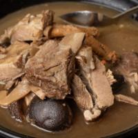 E1. Bak Kuet Tea 肉骨茶 · Pork rib with Chinese mushroom cooked in broth infused with herbs.