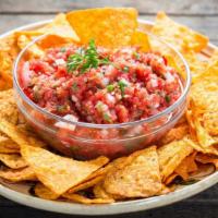 Chips & Salsa · Our in-house-made roasted secret salsa with chips. <br />*Roasted secret salsa contains toma...