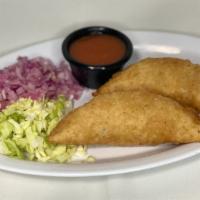 Empanadas · Half folded handmade tortilla stuffed with Choice. Served with diced cabbage, onions and tom...