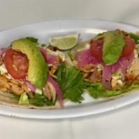 Tacos Chicken · Handmade tortillas. 
Lettuce, diced Cabbage, Chicken, Onion, Tomato, Avocado
*Sold Individua...
