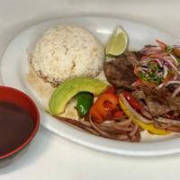Carne Asada · Grilled steak served on top of pan-fried onions and bell peppers with soy sauce. Served with...