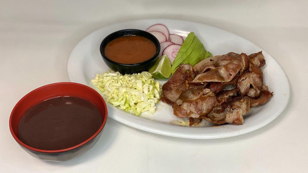 Zalado · Pork marinated with salt, served with diced cabbage, sliced avocado, roasted tomato sauce, sliced radish and a side of black beans puree.