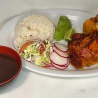 Pollo Asado / Roasted Chicken · Whole chicken leg marinated with achiote, served with a side salad, and a side of rice and b...