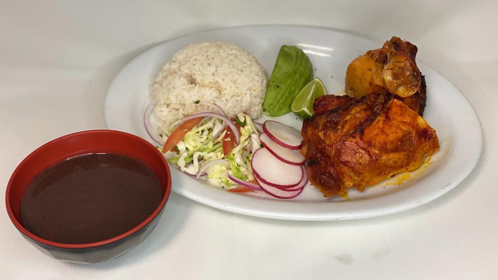 Pollo Asado / Roasted Chicken · Whole chicken leg marinated with achiote, served with a side salad, and a side of rice and beans.