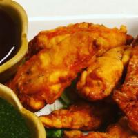 Chicken Pakora · Succulent marinated pieces of chicken dipped in batter and deep fried.