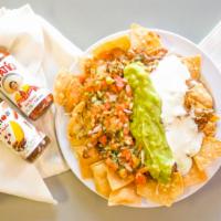 Super Nachos · Chips, refried  beans, pico de Gallo , sour cream, guacamole and cheese with choice of meat.