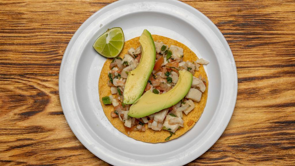 Tostada De Ceviche · Seafood fish or shrimp tostada shell with lime, onions, tomatoes, cilantro and avocado.