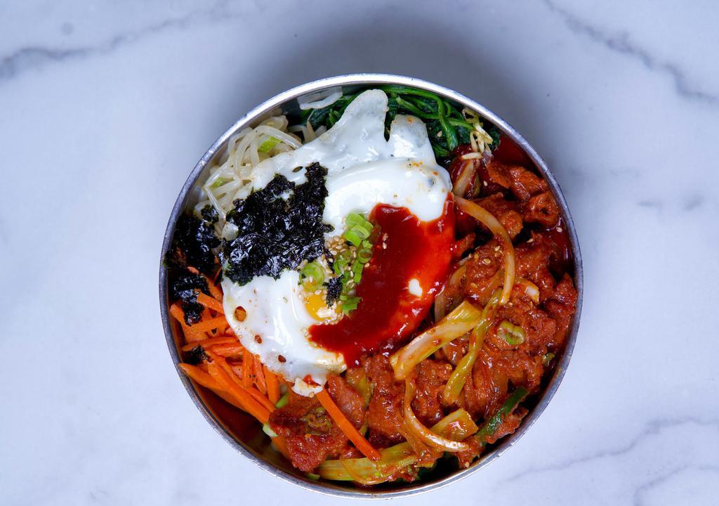 Bi Bim Bap · Bibimbap is a Korean rice bowl topped with an array of vegetables and meat and served with a gochujang sauce.