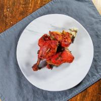 Tandoori Chicken · Half chicken marinated with ginger, garlic, yogurt, mustard and spices and roasted in our tr...